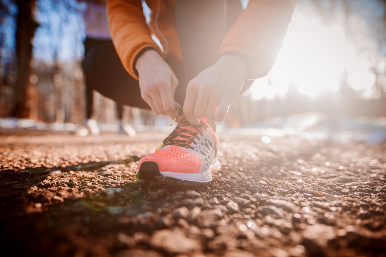 woman tying her shoe laces up during a run
