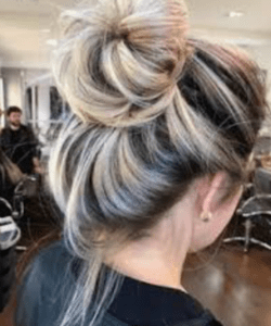 unrecognisable woman with messy bun