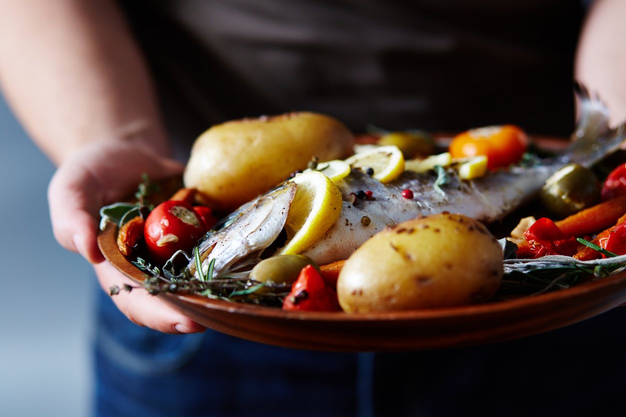 meal with baked fish, potato and lemon