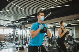 working out in a gym with a face mask on after the pandemic