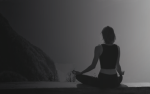 woman meditating black and white