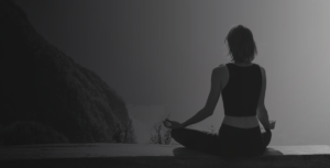 woman meditating black and white